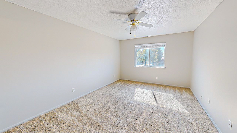 carpeted bedroom with ceiling fan